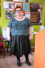 Load image into Gallery viewer, Kim wearing Bumbletee in front of a green wall with posters